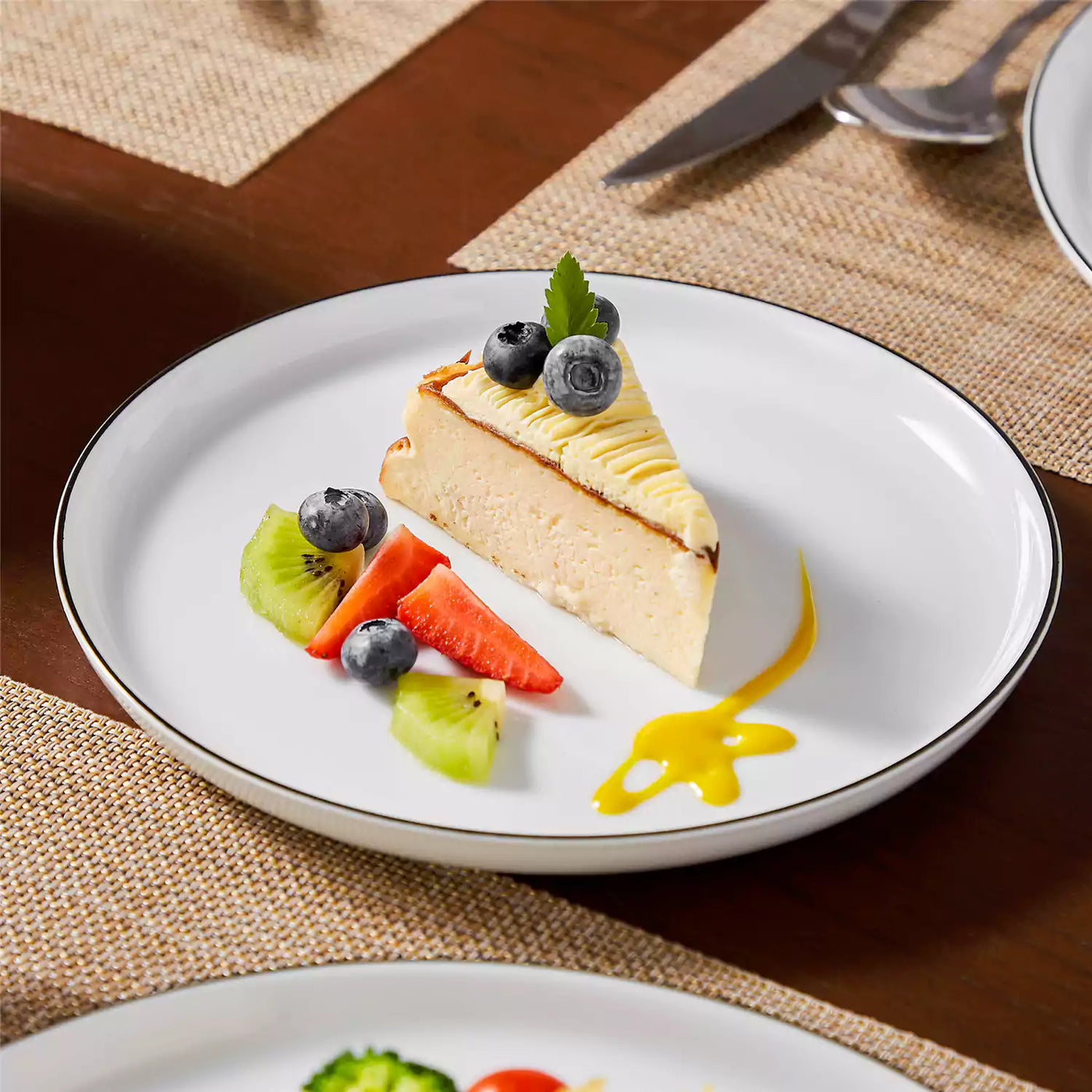 LEXI off-white porcelain dinnerware set including arc-shaped plates with lifted rims and deep rounded bowls#color_black-trim