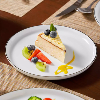 LEXI off-white porcelain dinnerware set including arc-shaped plates with lifted rims and deep rounded bowls#color_black-trim