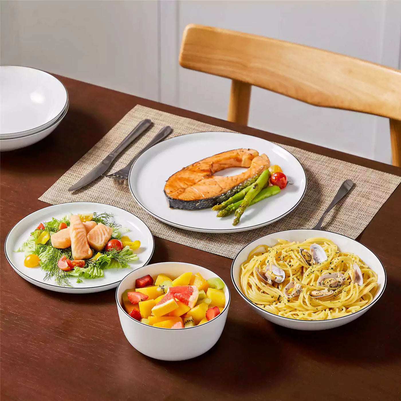 LEXI off-white porcelain dinnerware set including arc-shaped plates with lifted rims and deep rounded bowls#color_black-trim