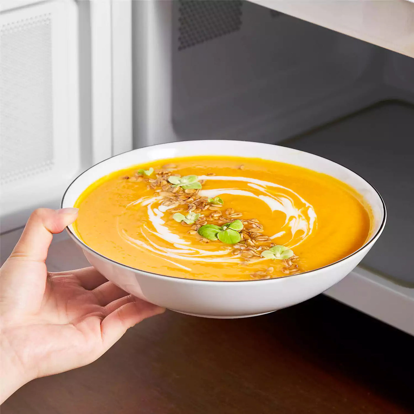 LEXI off-white porcelain dinnerware set including arc-shaped plates with lifted rims and deep rounded bowls#color_black-trim