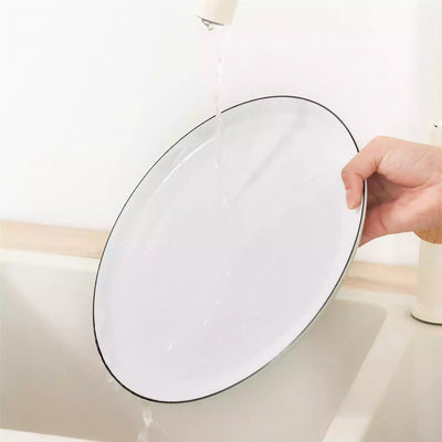 LEXI off-white porcelain dinnerware set including arc-shaped plates with lifted rims and deep rounded bowls#color_black-trim