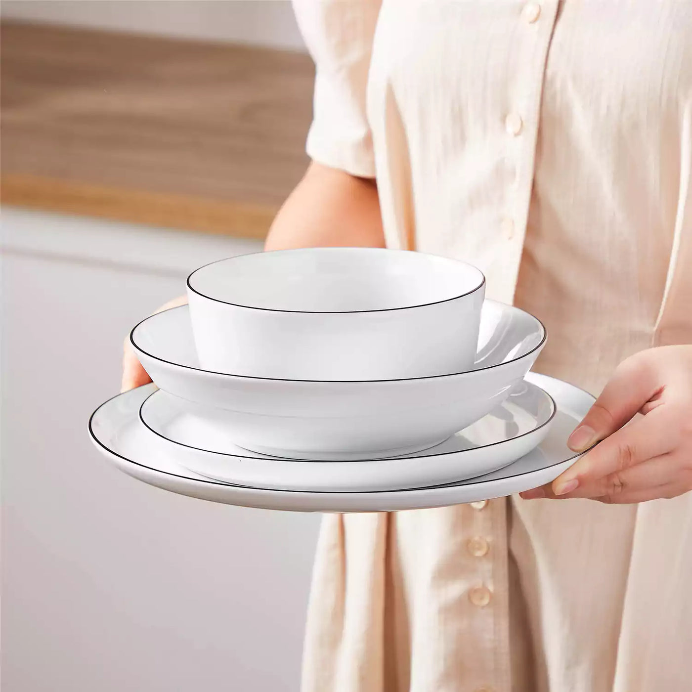LEXI off-white porcelain dinnerware set including arc-shaped plates with lifted rims and deep rounded bowls#color_black-trim