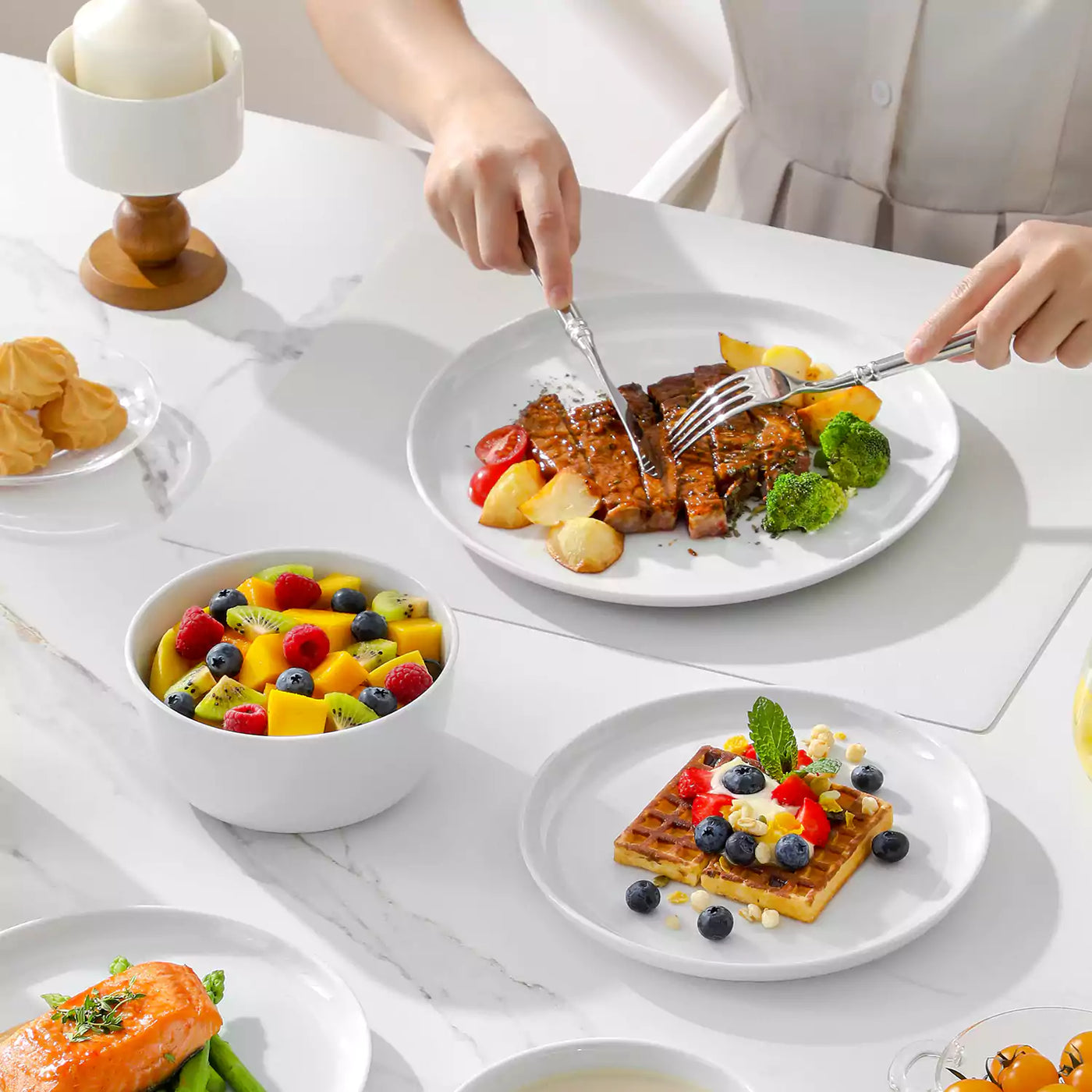 LEXI off-white porcelain dinnerware set including arc-shaped plates with lifted rims and deep rounded bowls#color_white