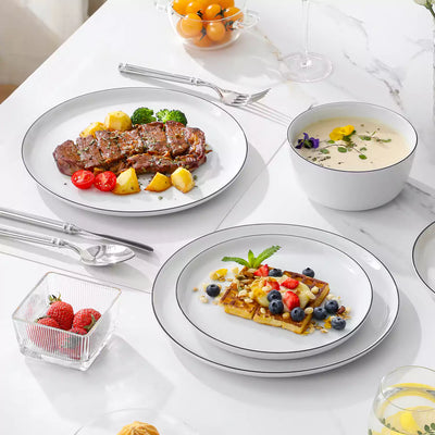 LEXI off-white porcelain dinnerware set including arc-shaped plates with lifted rims and deep rounded bowls#color_black-trim