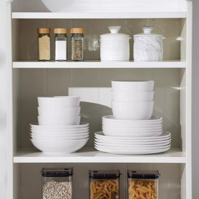 LEXI off-white porcelain dinnerware set including arc-shaped plates with lifted rims and deep rounded bowls#color_white