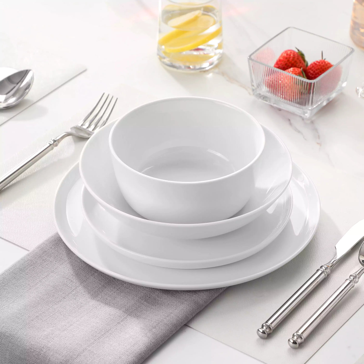 LEXI off-white porcelain dinnerware set including arc-shaped plates with lifted rims and deep rounded bowls#color_white