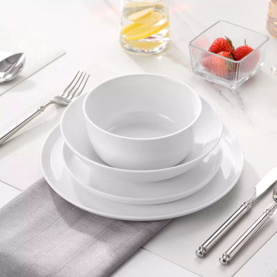 LEXI off-white porcelain dinnerware set including arc-shaped plates with lifted rims and deep rounded bowls#color_white