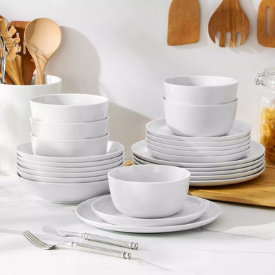 LEXI off-white porcelain dinnerware set including arc-shaped plates with lifted rims and deep rounded bowls#color_white