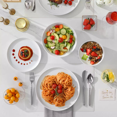 LEXI off-white porcelain dinnerware set including arc-shaped plates with lifted rims and deep rounded bowls#color_white