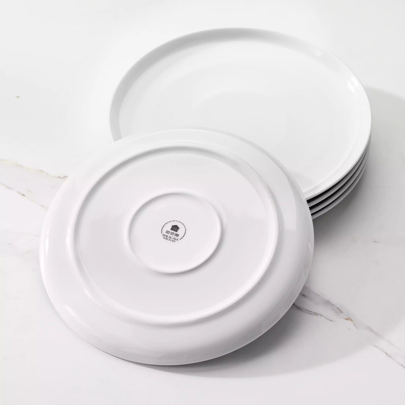 LEXI off-white porcelain dinnerware set including arc-shaped plates with lifted rims and deep rounded bowls#color_white