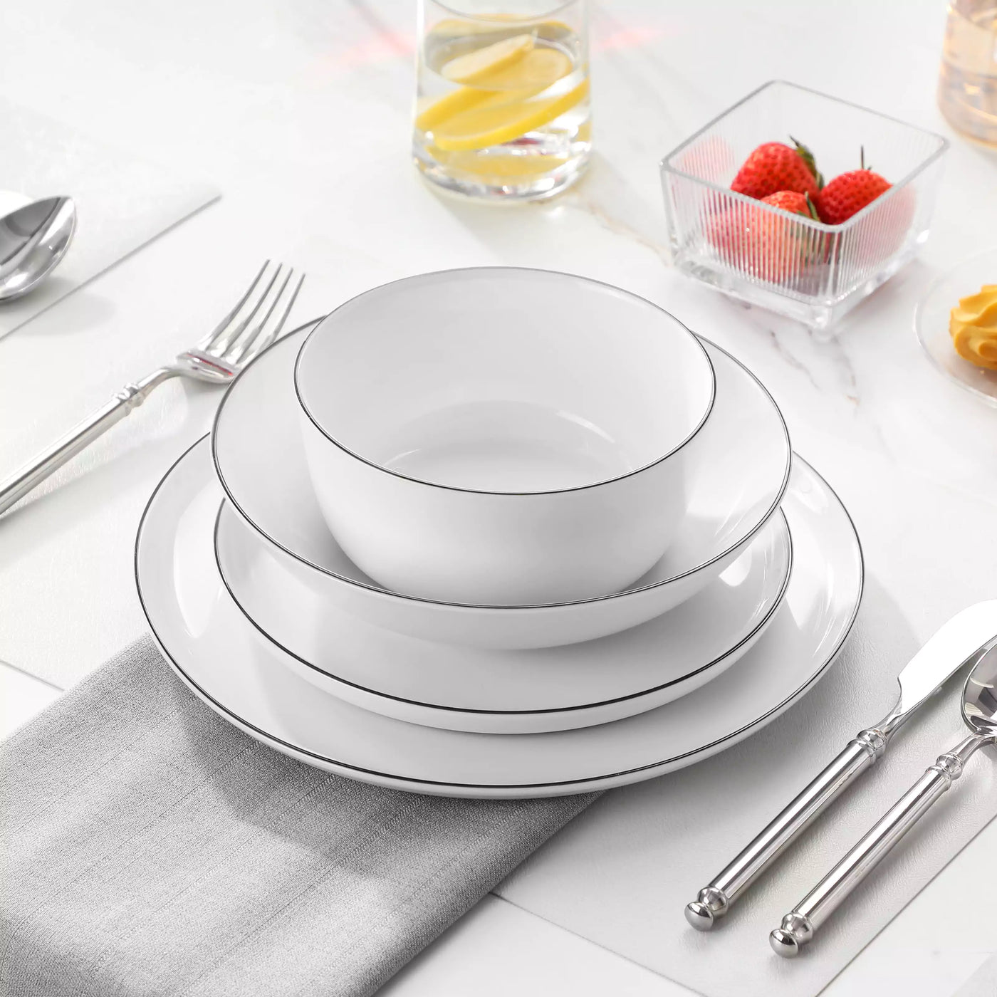 LEXI off-white porcelain dinnerware set including arc-shaped plates with lifted rims and deep rounded bowls#color_black-trim