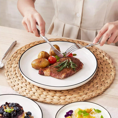 MINA porcelain dinnerware set featuring curved-edge plates and bowls with lifted rims#color_black-trim