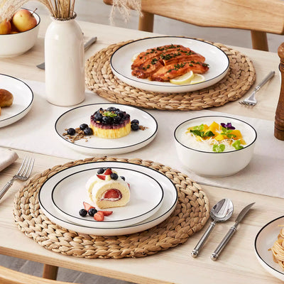 MINA porcelain dinnerware set featuring curved-edge plates and bowls with lifted rims#color_black-trim