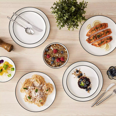 MINA porcelain dinnerware set featuring curved-edge plates and bowls with lifted rims#color_black-trim