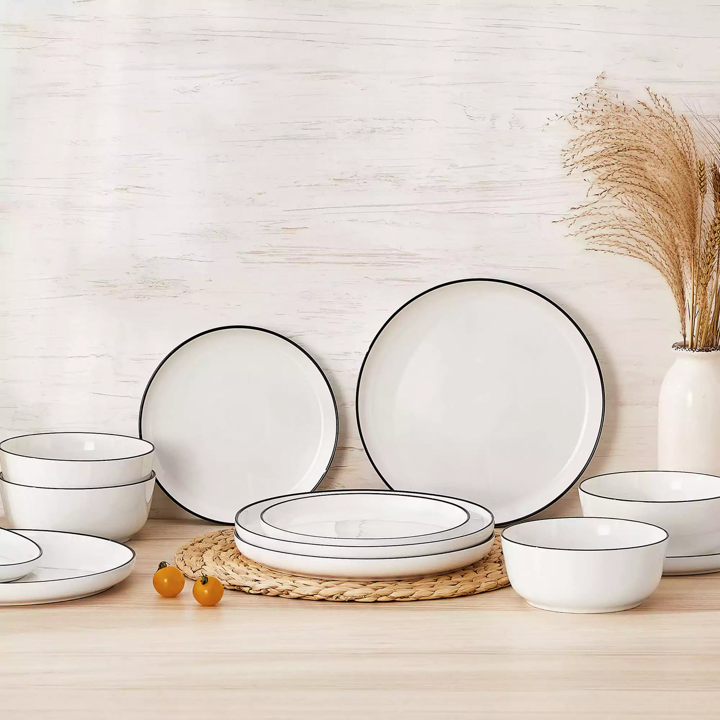 MINA porcelain dinnerware set featuring curved-edge plates and bowls with lifted rims#color_black-trim
