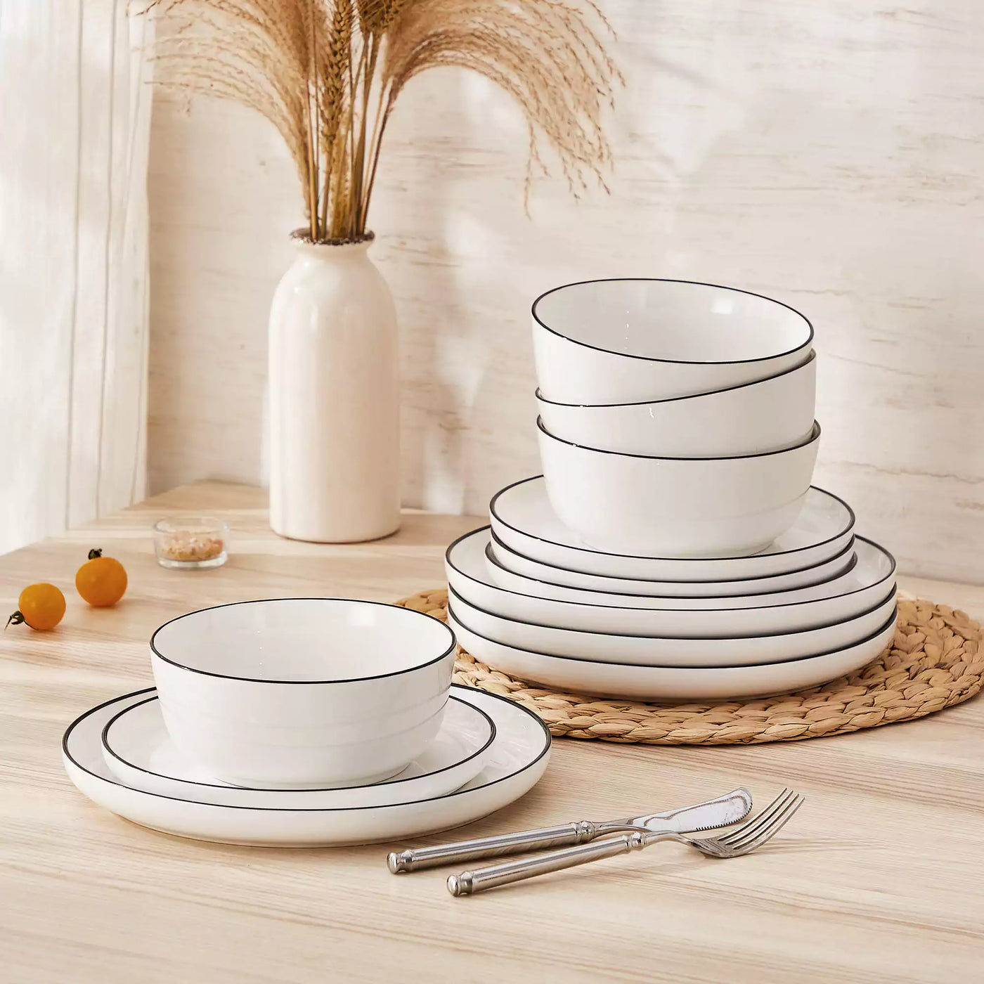 MINA porcelain dinnerware set featuring curved-edge plates and bowls with lifted rims#color_black-trim
