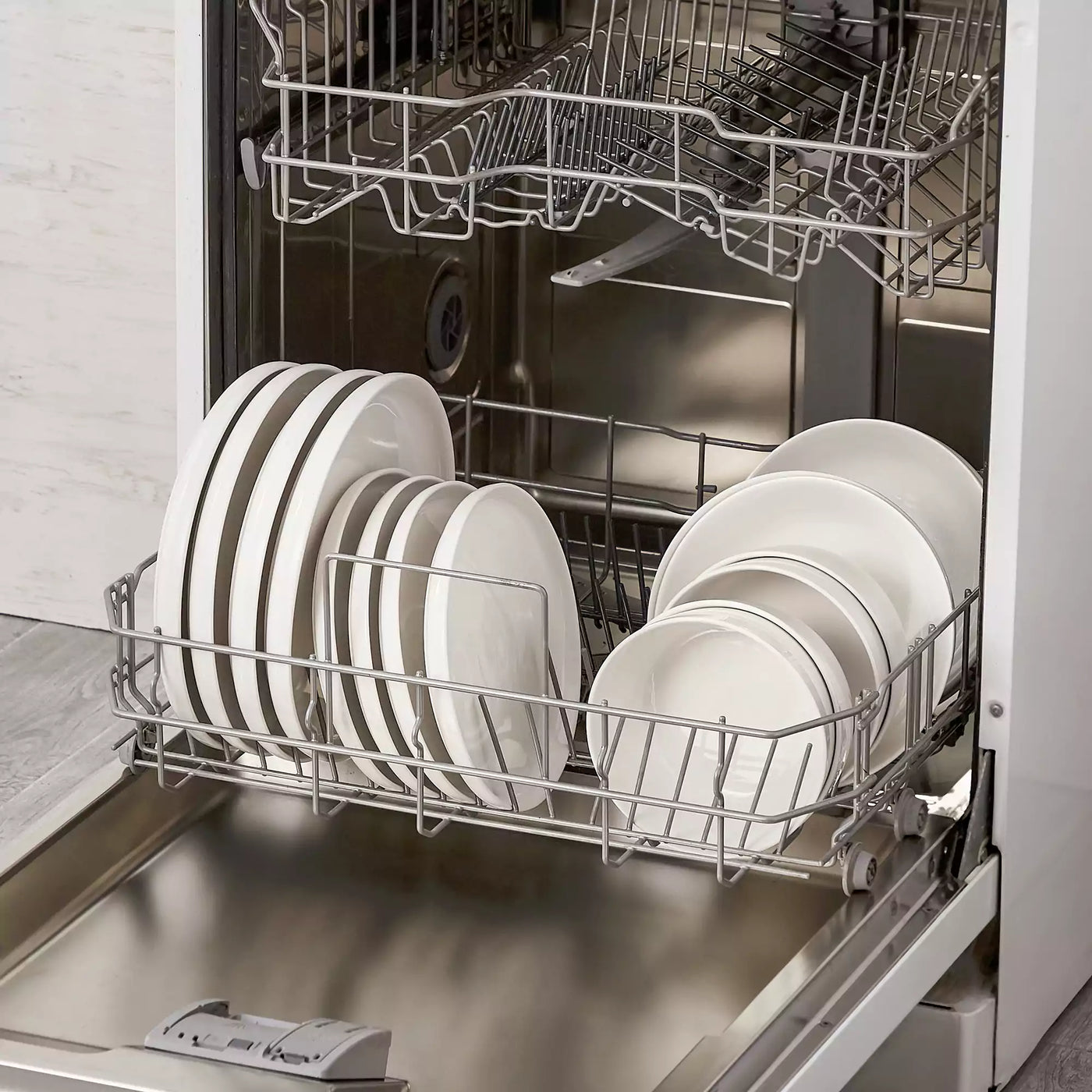 MINA porcelain dinnerware set featuring curved-edge plates and bowls with lifted rims.#color_ivory-white