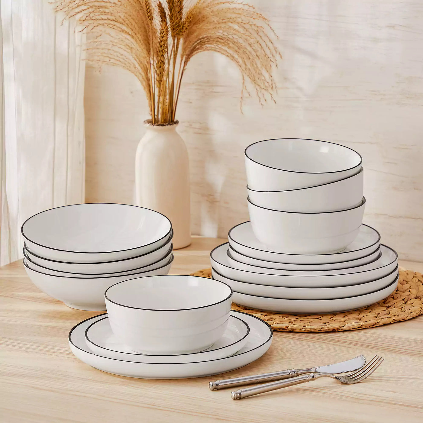 MINA porcelain dinnerware set featuring curved-edge plates and bowls with lifted rims#color_black-trim