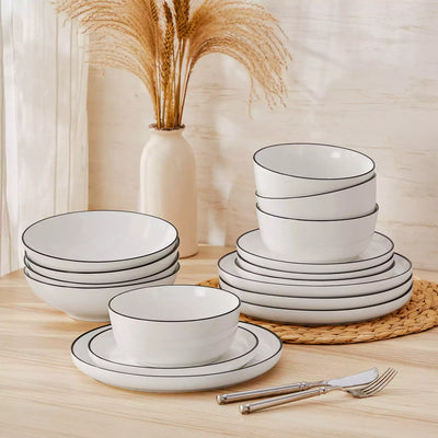 MINA porcelain dinnerware set featuring curved-edge plates and bowls with lifted rims#color_black-trim