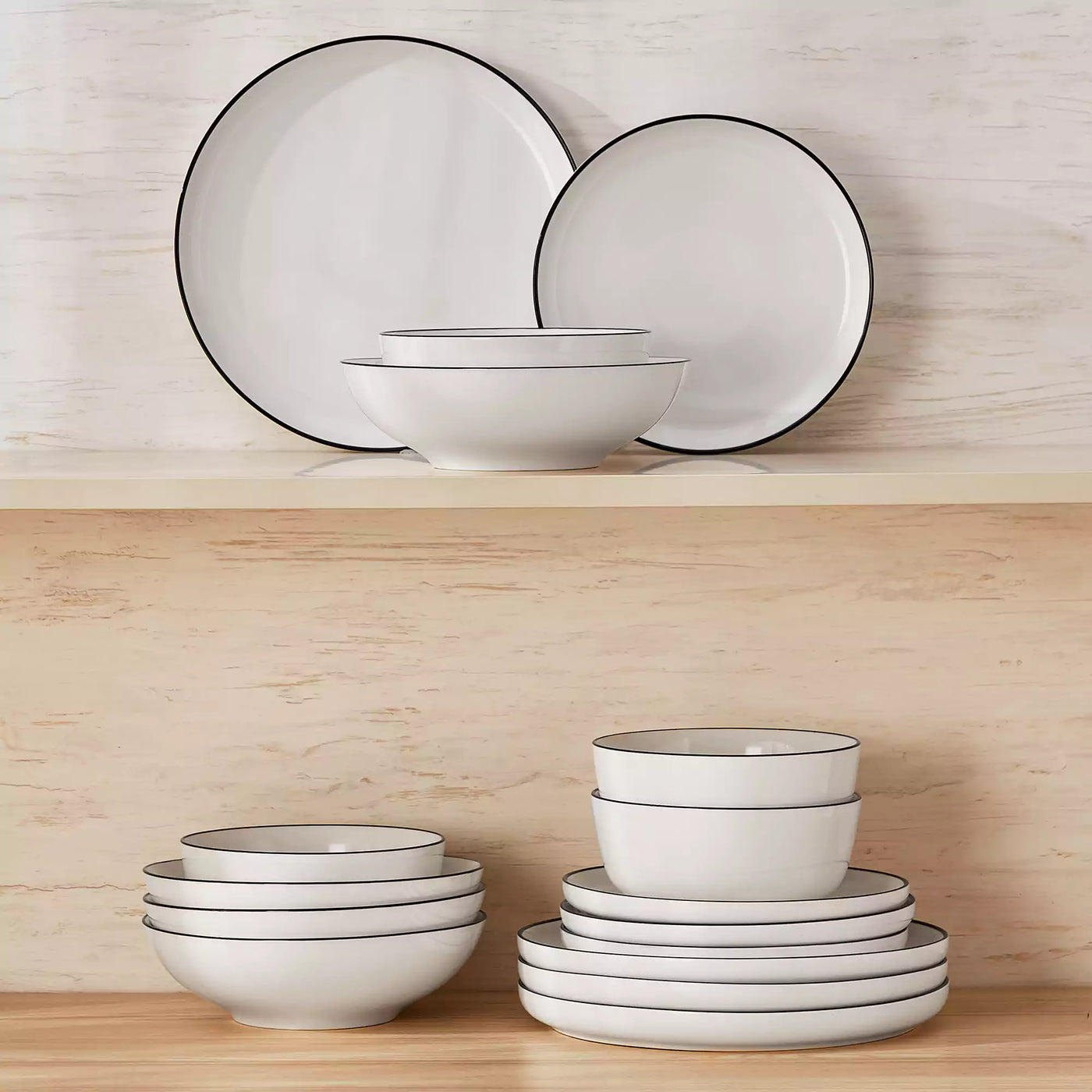 MINA porcelain dinnerware set featuring curved-edge plates and bowls with lifted rims#color_black-trim