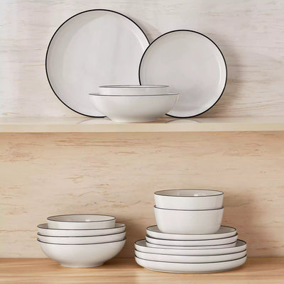MINA porcelain dinnerware set featuring curved-edge plates and bowls with lifted rims#color_black-trim