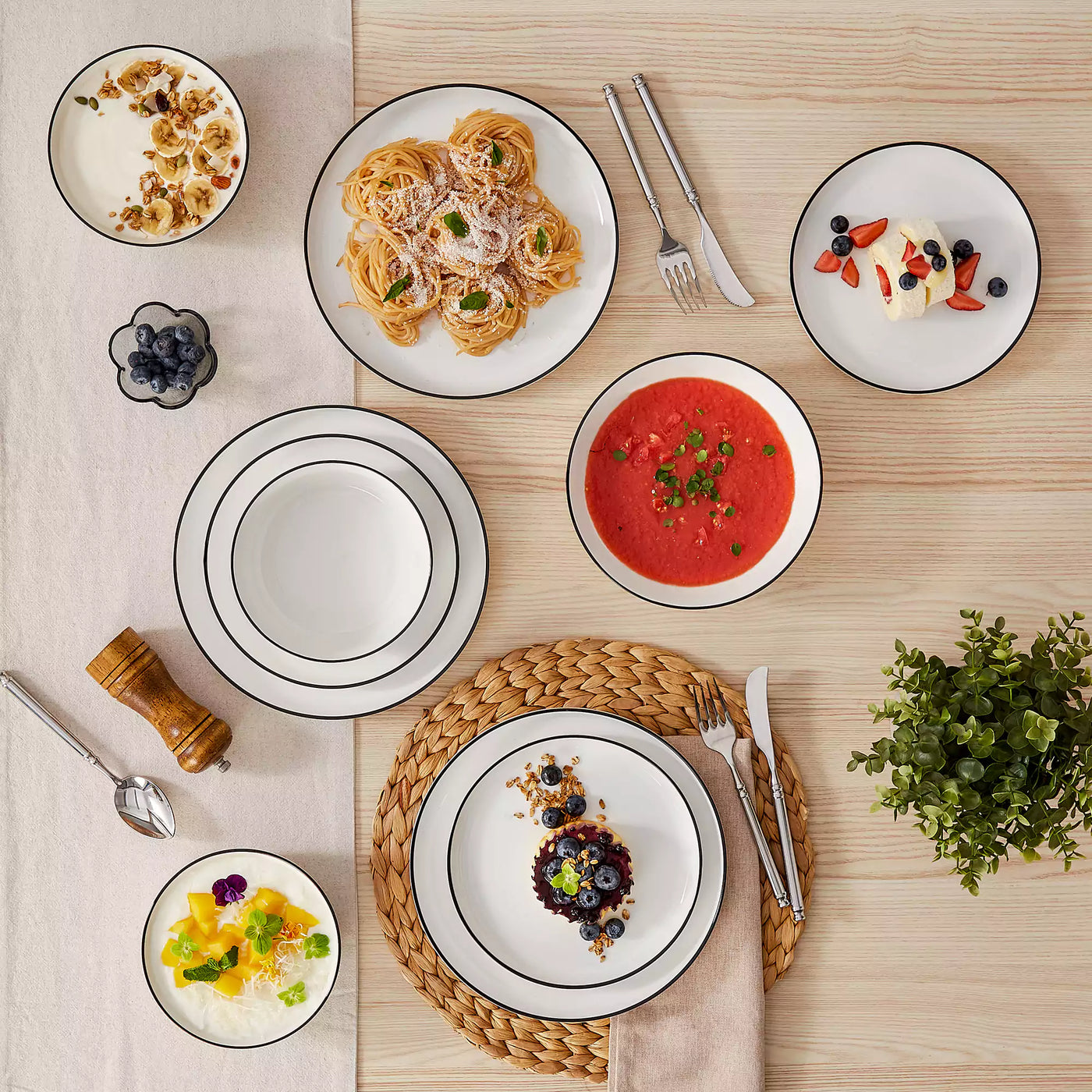 MINA porcelain dinnerware set featuring curved-edge plates and bowls with lifted rims#color_black-trim