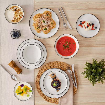 MINA porcelain dinnerware set featuring curved-edge plates and bowls with lifted rims#color_black-trim