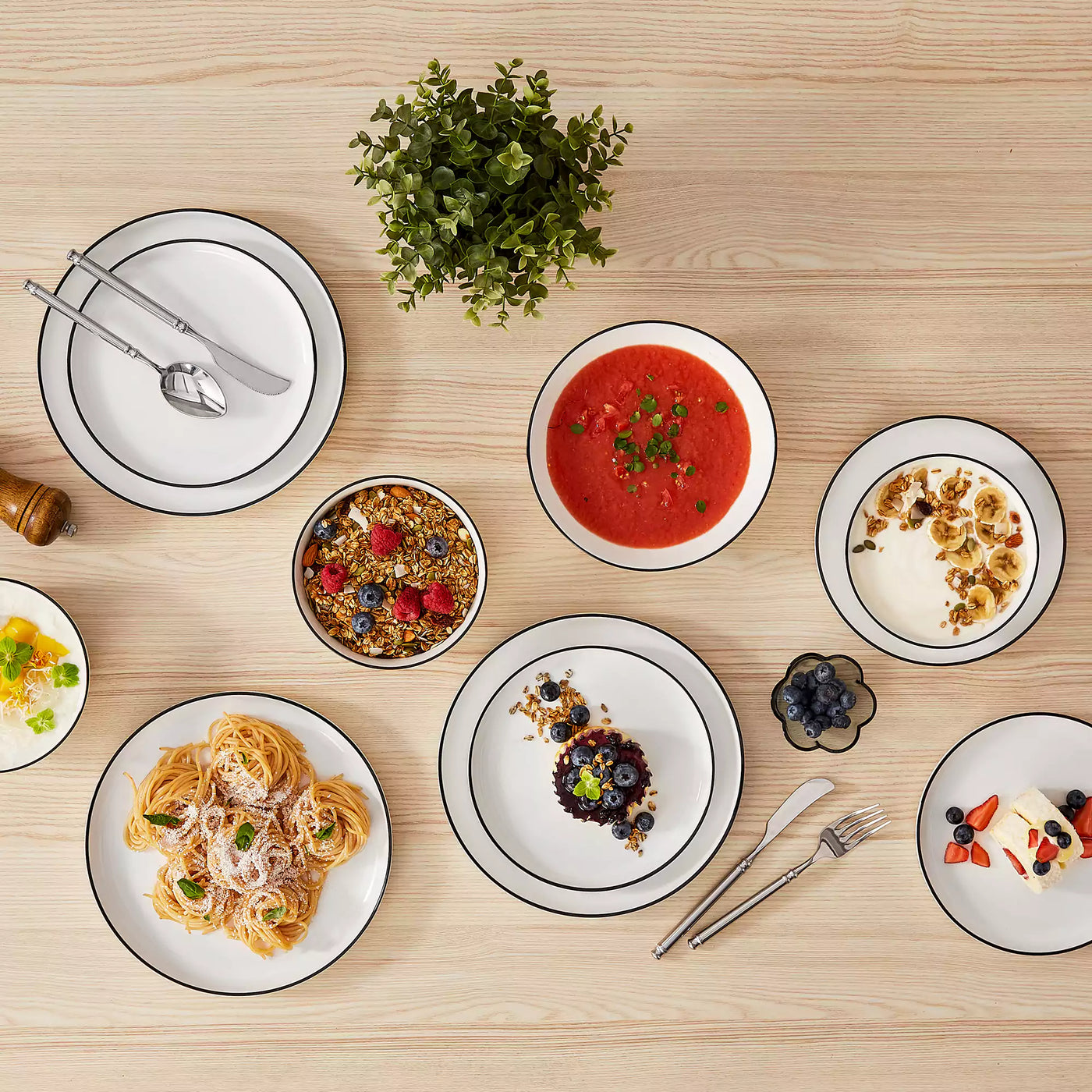 MINA porcelain dinnerware set featuring curved-edge plates and bowls with lifted rims#color_black-trim