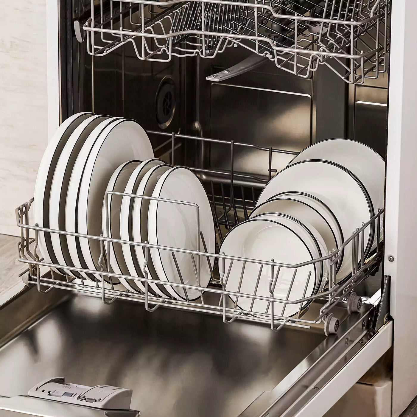 MINA porcelain dinnerware set featuring curved-edge plates and bowls with lifted rims#color_black-trim