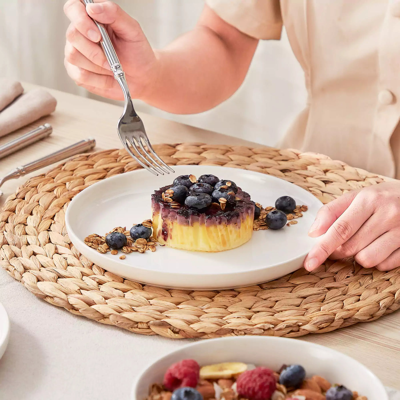 MINA porcelain dinnerware set featuring curved-edge plates and bowls with lifted rims.#color_ivory-white