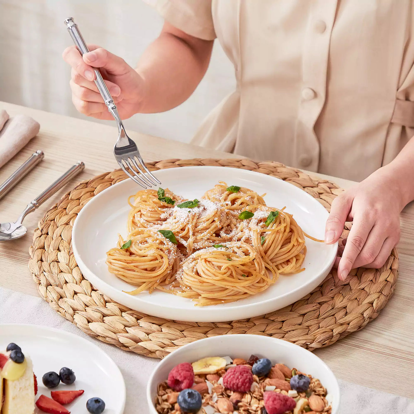 MINA porcelain dinnerware set featuring curved-edge plates and bowls with lifted rims.#color_ivory-white