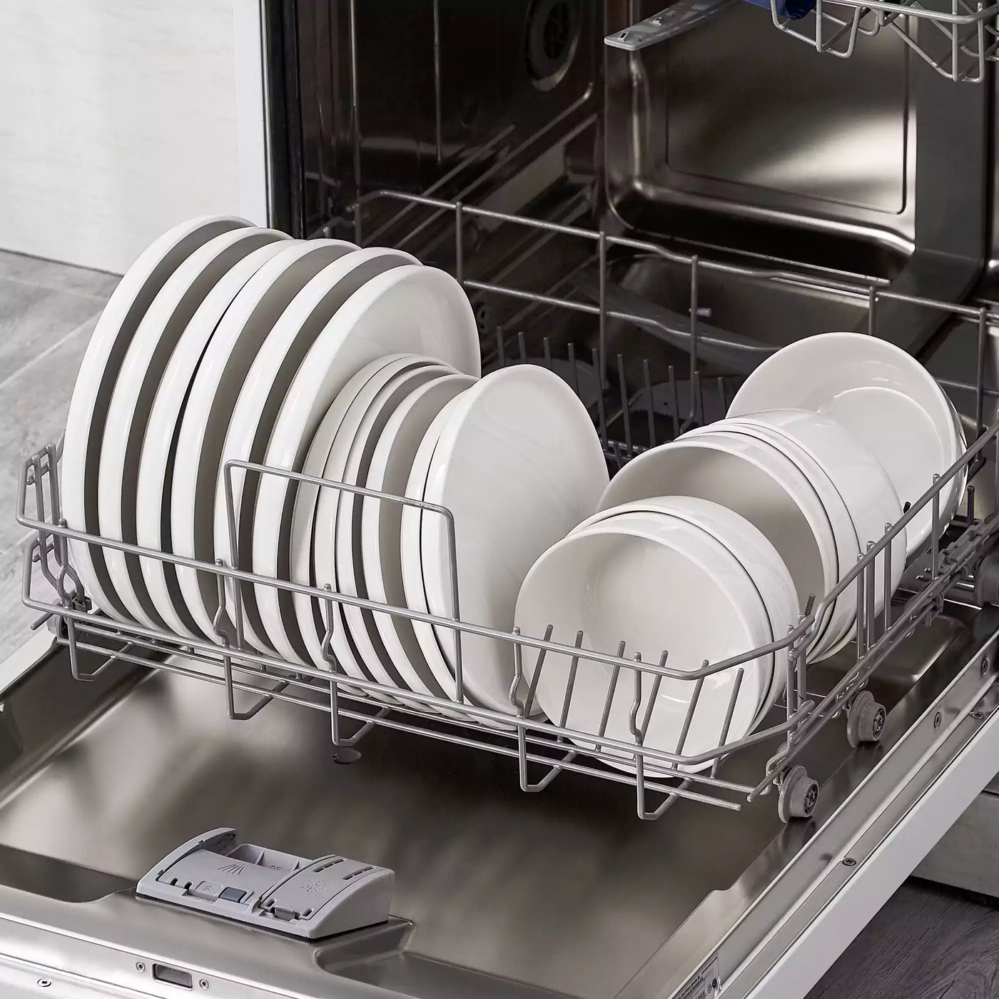 MINA porcelain dinnerware set featuring curved-edge plates and bowls with lifted rims.#color_ivory-white