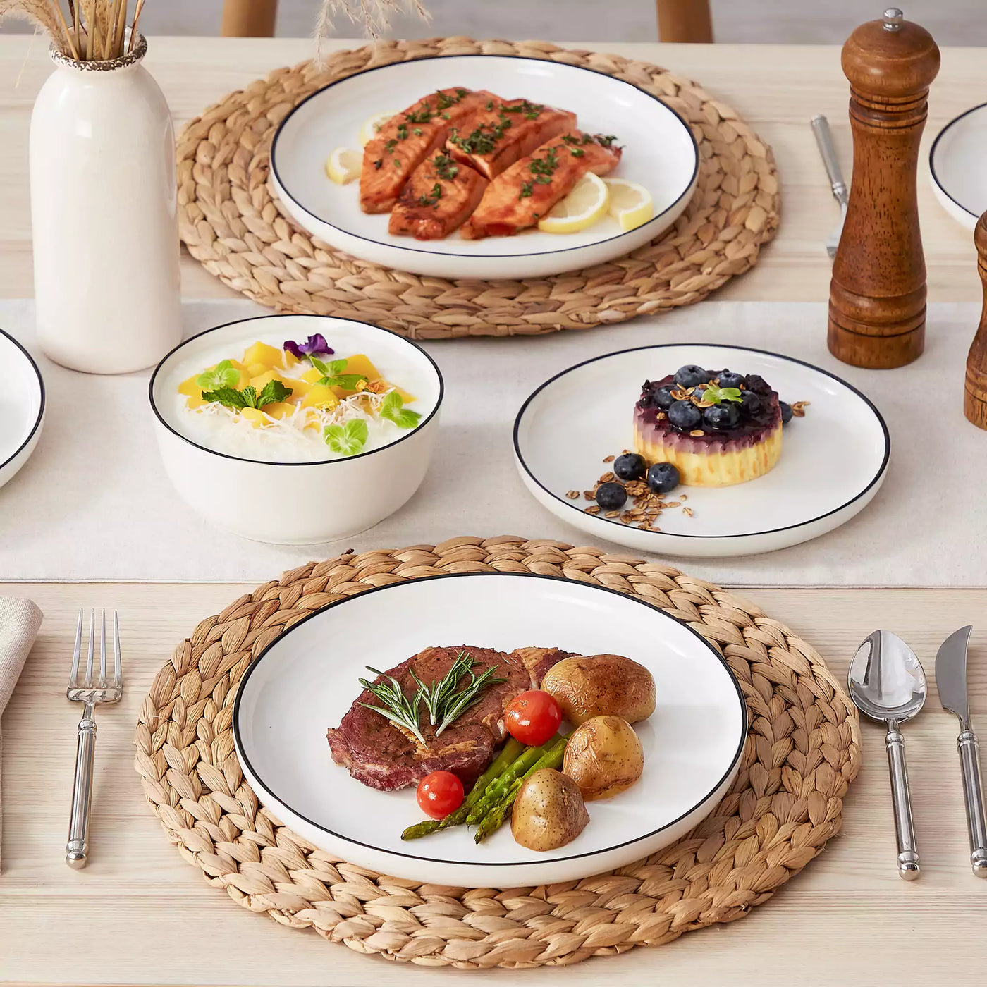 MINA porcelain dinnerware set featuring curved-edge plates and bowls with lifted rims#color_black-trim