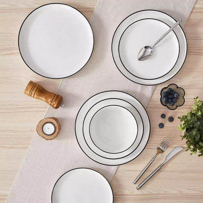 MINA porcelain dinnerware set featuring curved-edge plates and bowls with lifted rims#color_black-trim