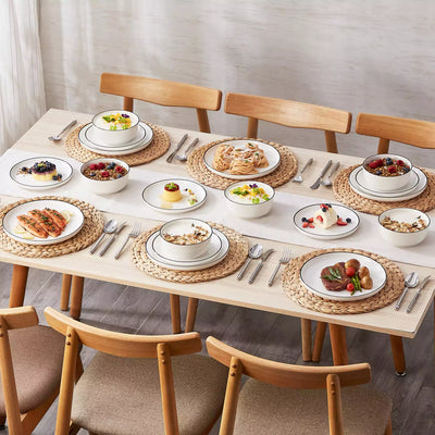 MINA porcelain dinnerware set featuring curved-edge plates and bowls with lifted rims#color_black-trim