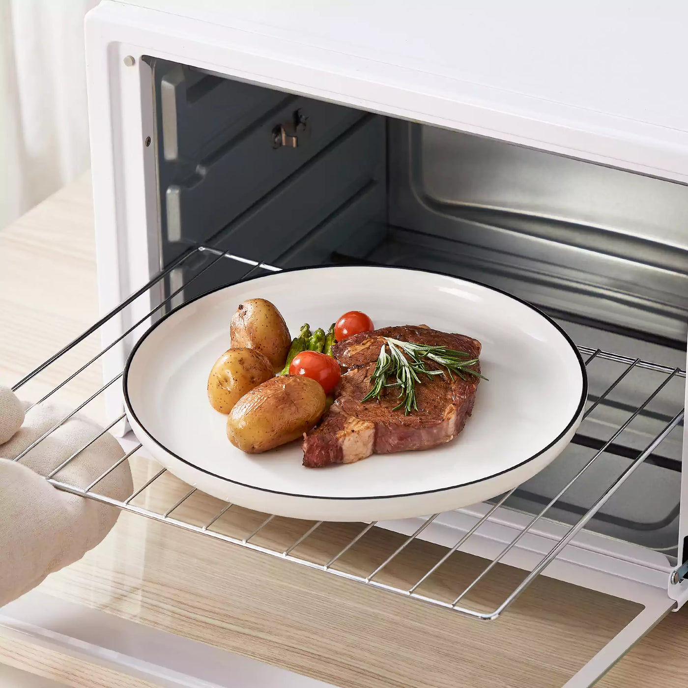 MINA porcelain dinnerware set featuring curved-edge plates and bowls with lifted rims#color_black-trim