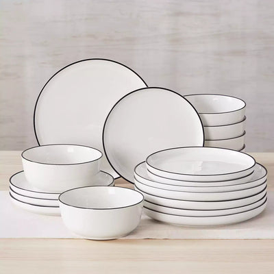 MINA porcelain dinnerware set featuring curved-edge plates and bowls with lifted rims#color_black-trim
