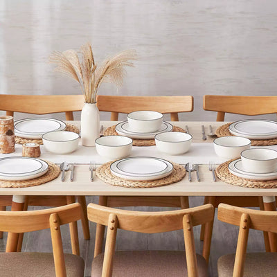 MINA porcelain dinnerware set featuring curved-edge plates and bowls with lifted rims#color_black-trim