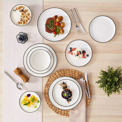 MINA porcelain dinnerware set featuring curved-edge plates and bowls with lifted rims#color_black-trim