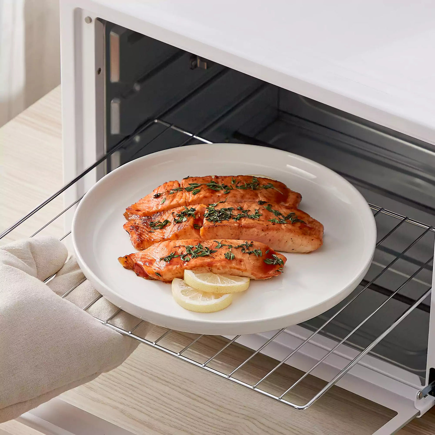 MINA porcelain dinnerware set featuring curved-edge plates and bowls with lifted rims.#color_ivory-white