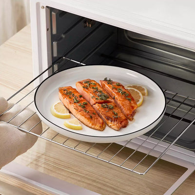 MINA porcelain dinnerware set featuring curved-edge plates and bowls with lifted rims#color_black-trim