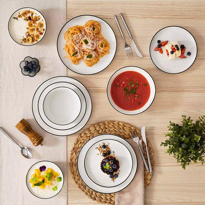 MINA porcelain dinnerware set featuring curved-edge plates and bowls with lifted rims#color_black-trim
