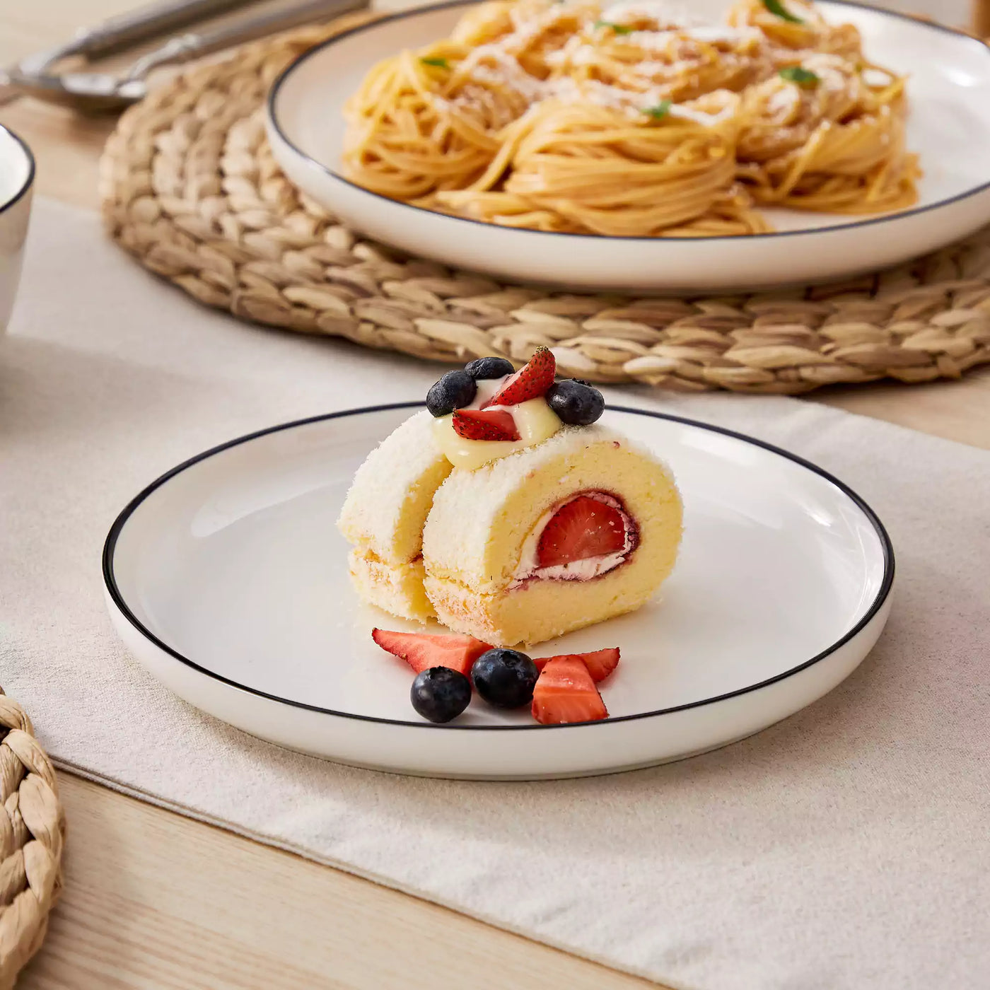 MINA porcelain dinnerware set featuring curved-edge plates and bowls with lifted rims#color_black-trim