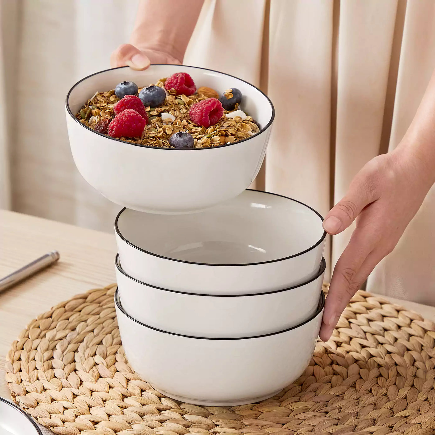 MINA porcelain dinnerware set featuring curved-edge plates and bowls with lifted rims#color_black-trim