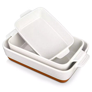 Set of three ceramic baking dishes with brown bottoms on a white background