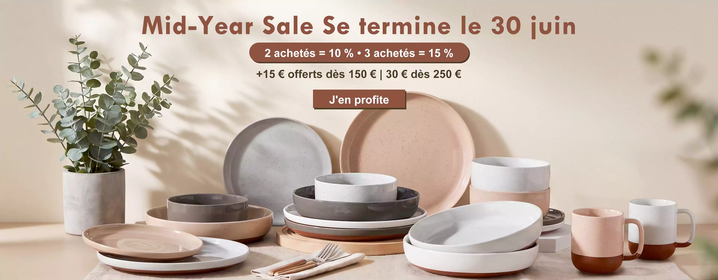 Dining table with ceramic plates and bowls, promotional text for a mid-year sale.