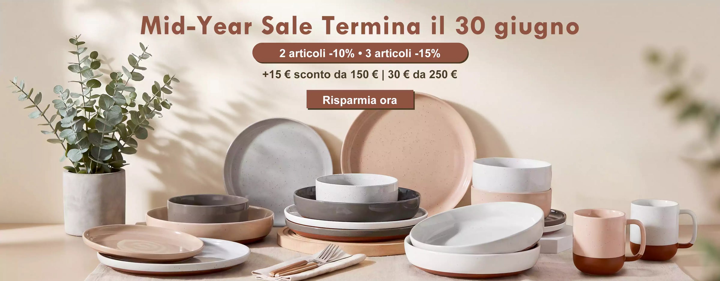 Dining table with ceramic plates and bowls, potted plant, and promotional text for a mid-year sale.
